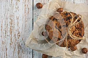 Homemade cookies with chocolate, nuts and milk on a wooden table and an art phone in the morning. Close up. Breakfast.