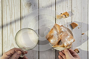 Homemade cookies with chocolate, nuts, raisins, milk on a wooden background. Breakfast.