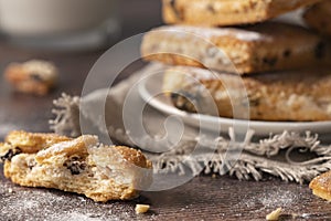 Homemade cookies with chocolate, nuts, raisins, milk on a wooden background. Breakfast.