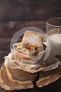 Homemade cookies with chocolate, nuts, raisins, milk on a wooden background. Breakfast.