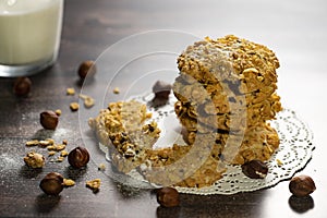 Homemade cookies with chocolate, nuts, raisins, milk on a wooden background. Breakfast.