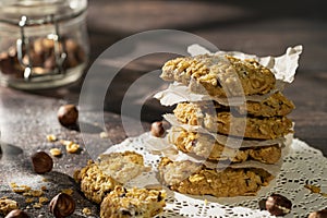 Homemade cookies with chocolate, nuts, raisins, milk on a wooden background. Breakfast.