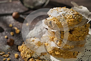 Homemade cookies with chocolate, nuts, raisins, milk on a wooden background. Breakfast.