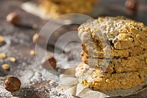 Homemade cookies with chocolate, nuts, raisins, milk on a wooden background. Breakfast.