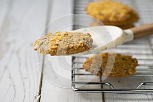 Homemade cookies with chocolate, nuts, raisins, milk on a wooden background. Breakfast.