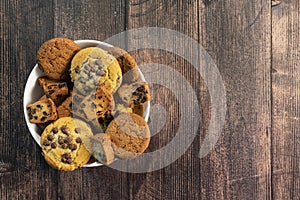 Homemade cookies with chocolate, nuts on a wooden background