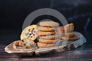 Homemade cookies with chocolate, nuts on a wooden background  with a background blur.