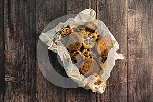 Homemade cookies with chocolate, nuts on a wooden background  with a papier.
