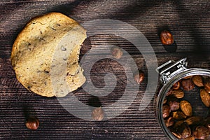 Homemade cookies with chocolate, nuts on a wooden table and an art background in the morning window light. Close up. Breakfast.