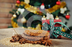 Homemade cookies with cinnamon on Christmas tree background