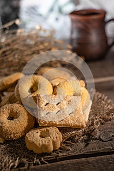 Homemade cookies with a cup of milk on a rural wooden background