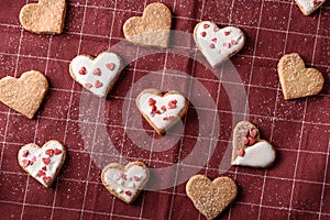 Homemade cookies hearts with frosting on Burgundy cloth napkin