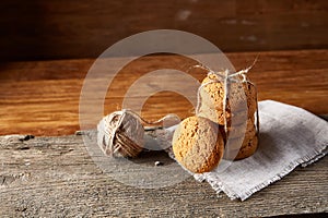 Homemade cookies on homespun napkin over wooden table, close-up, selective focus