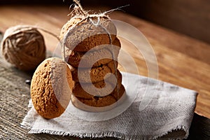Homemade cookies on homespun napkin over wooden table, close-up, selective focus