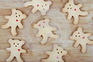 Homemade cookies in the shape of a bear cub on a wooden board
