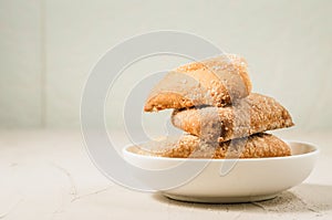homemade cookies on a white bowl/ homemade cookies on a white bowl on a concrete background, selective focus