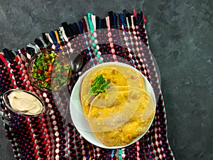 Homemade corn flatbread with cilantro green tomato salsa. Handmade mexican tortilla authentic textile Traditional Indian