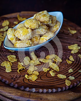 Homemade Cornflake cookies on a wooden background.