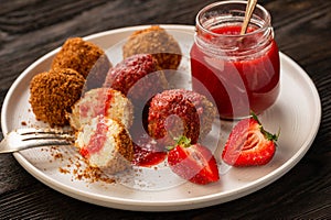 Homemade cottage cheese balls, hungarian sweet dessert served with strawberry mousse.