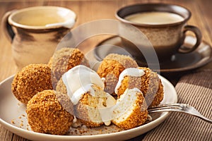 Homemade cottage cheese balls, hungarian sweet dessert served with sweat fraiche creme.