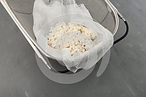 Homemade cottage cheese on cheesecloth. Natural dairy product. Organic eco healthy food
