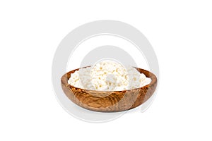 Homemade cottage cheese, curd in a wooden bowl isolated on a white background.