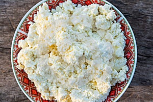 Homemade cottage cheese on old wooden table