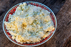 Homemade cottage cheese on old wooden table