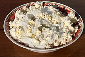 Homemade cottage cheese on old wooden table
