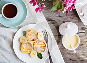 Homemade cottage cheese pancakes with banana, condensed milk,br