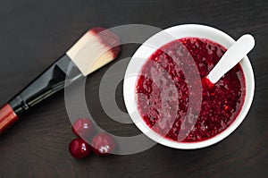 Homemade cranberry face mask scrub in a small white bowl. Diy cosmetics.