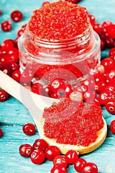 Homemade cranberry sugar scrub on a wooden background