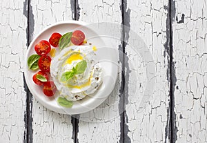 Homemade cream cheese  labneh wiht cherry tomatoes, basil and olive oil