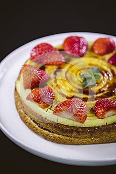 Homemade cream layer cake, fresh, colorful, and delicious dessert with juicy strawberries.