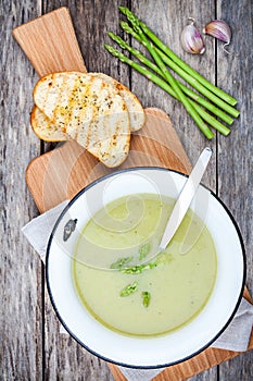 Homemade cream soup with asparagus and toasted ciabatta