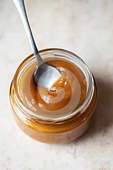 Homemade creamy caramel in a jar. Close up