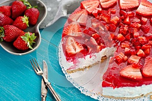 Homemade creamy dessert cake pie of red strawberry fresh fruit on blue wooden background