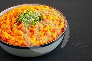 Homemade Creamy Mashed Sweet Potatoes with MIlk and Butter in a Bowl, side view. Copy space