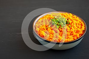 Homemade Creamy Mashed Sweet Potatoes with MIlk and Butter in a Bowl, side view. Copy space