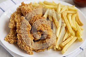 Homemade Crispy Chicken Tenders and French Fries, low angle view. Close-up