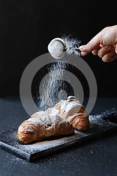 Homemade croisant on a black background photo