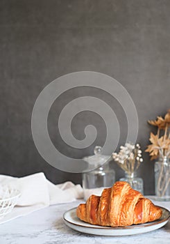 Homemade croissant on the kitchen table top. pastry and bakery or breakfast concept with Copyspace. vertical