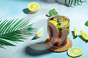 Homemade Cuba Libre with fresh lime, rum, cola, mint in the glass, banner, menu, recipe place for text