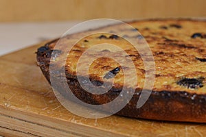 Homemade cupcake with raisins cools on a wooden board