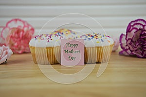 Homemade cupcakes with flowers and a happy mothers day note