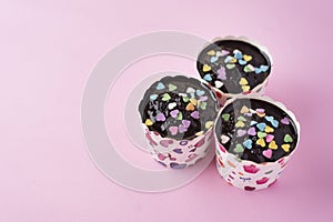 Homemade cupcakes on pink background