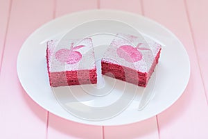 Homemade currant pastila on white plate with pink wooden background. Berry marshmallow paste