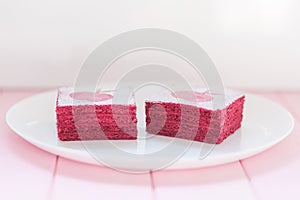 Homemade currant pastila on white plate with pink wooden background. Berry marshmallow paste