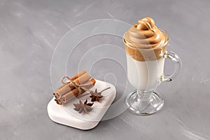Homemade Dalgona coffee in glass with ingredients. Recipe popular Korean drink latte with foam of instant coffee. Cinnamon and