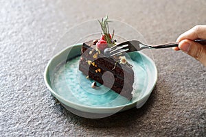 Homemade dark chocolate cake with fresh strawberry and blueberry on table, copy space.